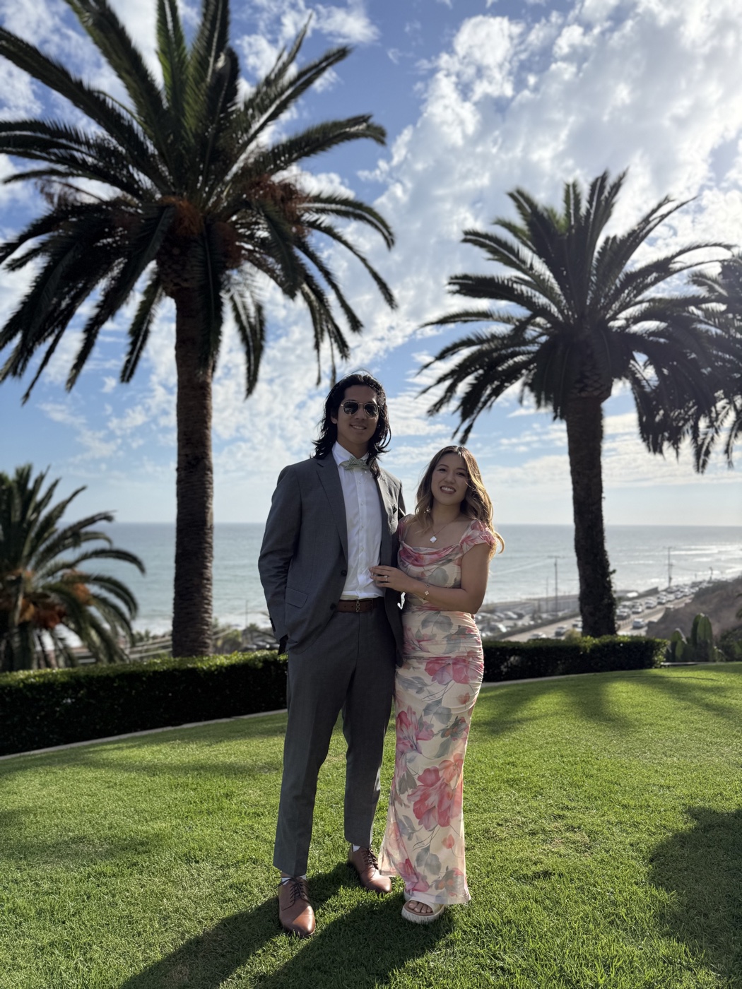 Derek and his wife together by the ocean